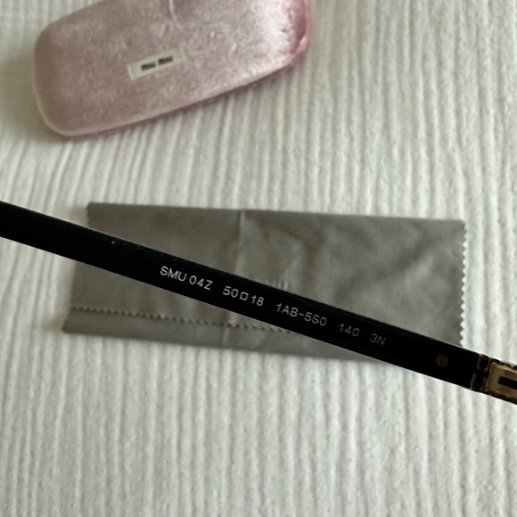 Miu Miu Black and Gold Oval Sunglasses